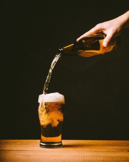 beer being poured into a glass
