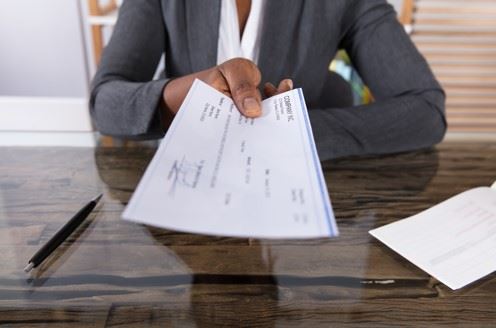 employer-handing-employee-a-paycheck